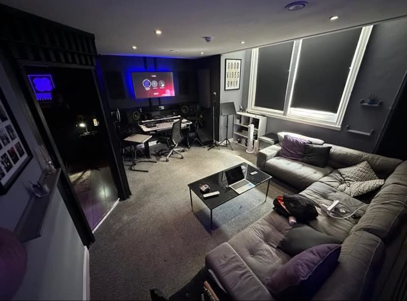 Studio A at Studio 88: desk, monitors and lounge under blue light